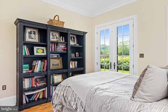 bedroom featuring access to exterior, wood-type flooring, and ornamental molding