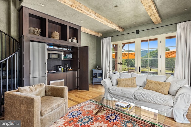 living room featuring french doors and light hardwood / wood-style floors