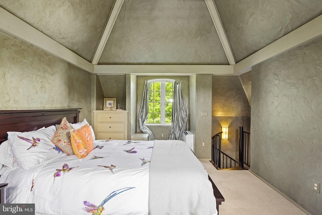 bedroom featuring light colored carpet and lofted ceiling