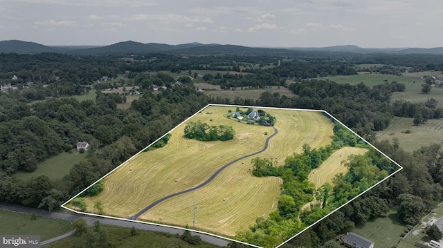 drone / aerial view featuring a mountain view and a rural view