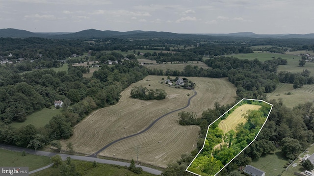 drone / aerial view featuring a mountain view and a rural view