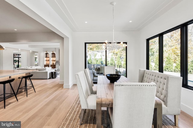 dining area featuring a chandelier and light hardwood / wood-style floors