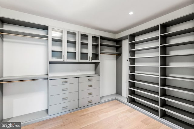 walk in closet featuring light hardwood / wood-style flooring