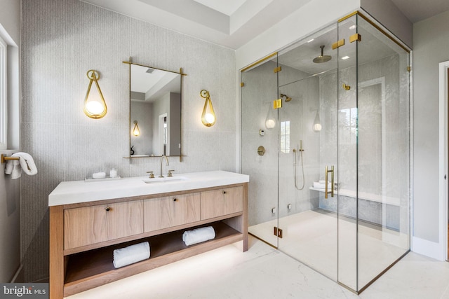 bathroom with vanity and a shower with door