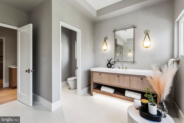 bathroom featuring vanity, hardwood / wood-style flooring, and toilet