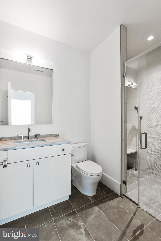 bathroom featuring vanity, toilet, tile patterned floors, and walk in shower