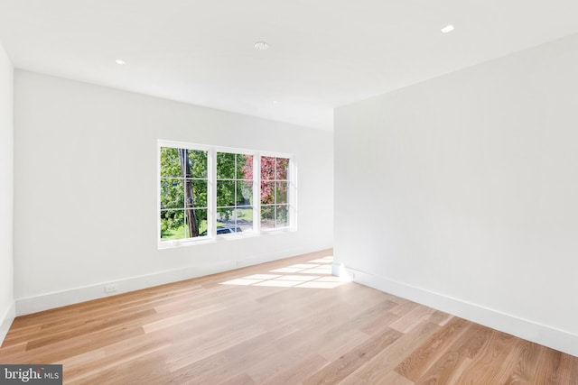 unfurnished room with light hardwood / wood-style floors