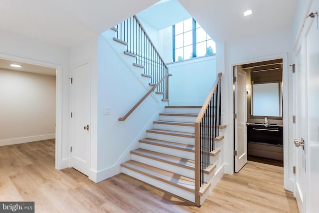 stairs featuring wood-type flooring