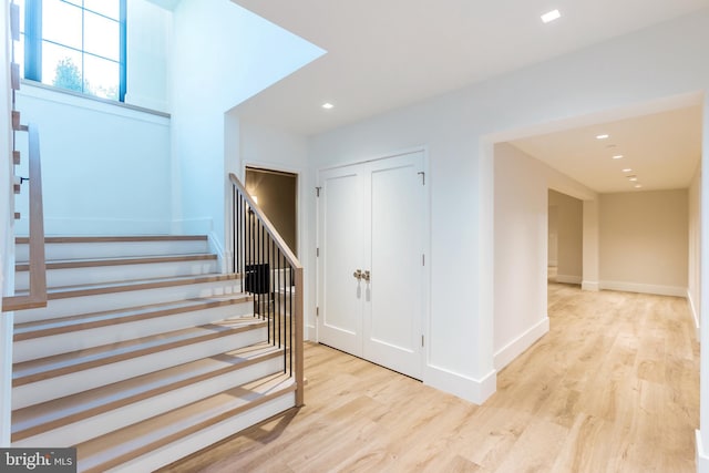 stairs with hardwood / wood-style floors