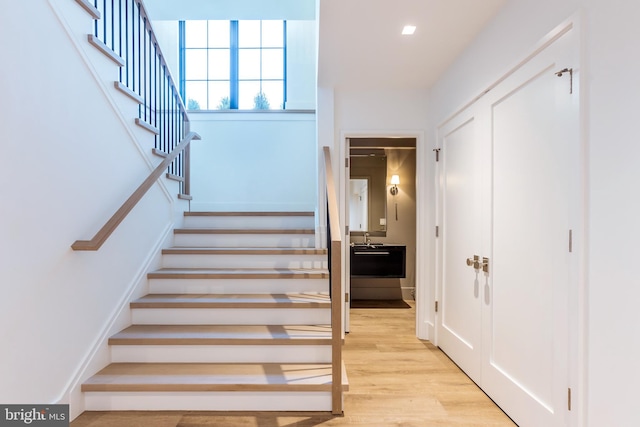 stairs featuring hardwood / wood-style floors