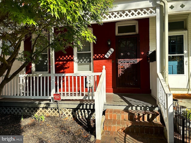 view of exterior entry with covered porch