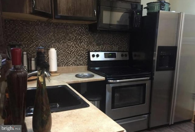 kitchen featuring appliances with stainless steel finishes and tasteful backsplash