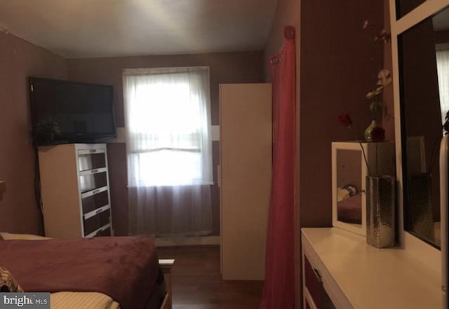 bedroom featuring dark hardwood / wood-style flooring