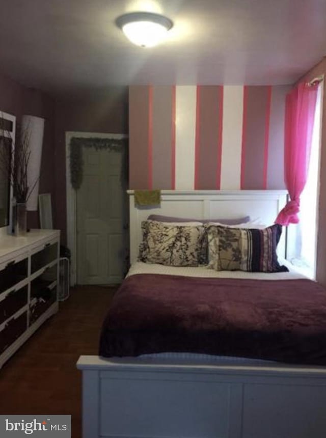 bedroom featuring dark wood-type flooring