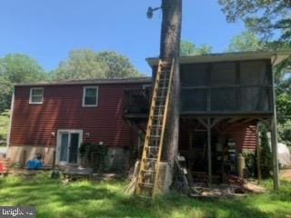 back of property with a sunroom