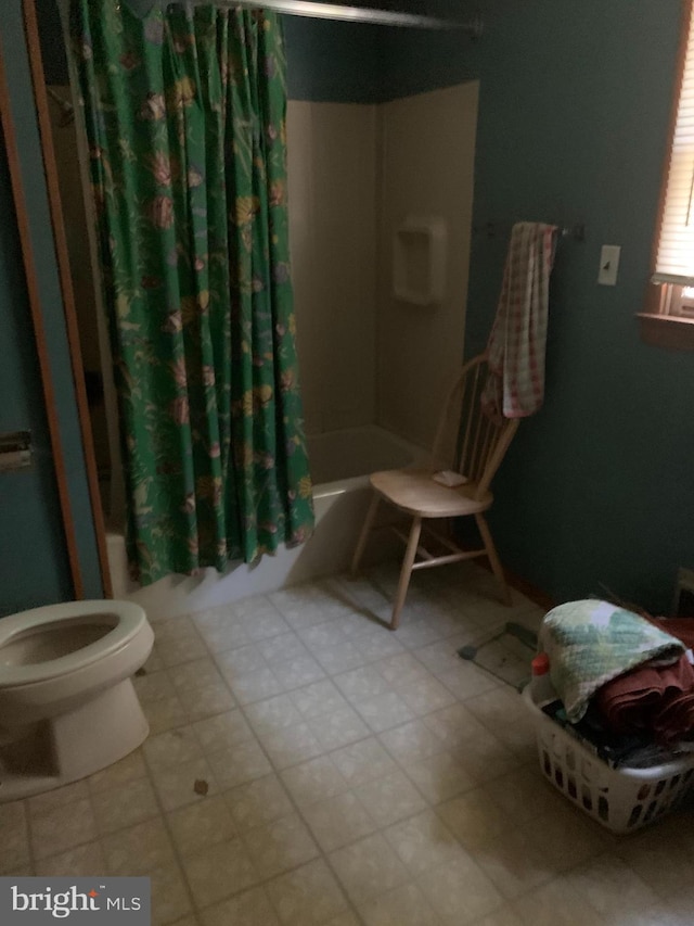 bathroom with tile floors, shower / bath combo, and toilet