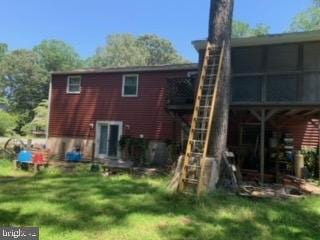 rear view of house with a lawn