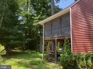 view of side of property featuring a sunroom