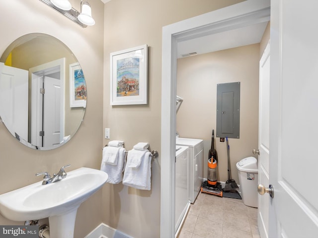 bathroom featuring sink, tile floors, and independent washer and dryer