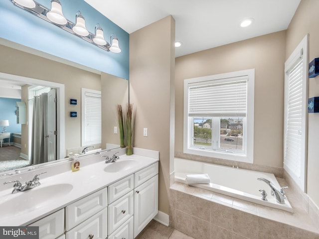 bathroom featuring tile floors, tiled bath, and dual bowl vanity