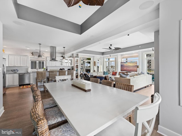 dining room featuring french doors, ceiling fan, hardwood / wood-style flooring, and a raised ceiling