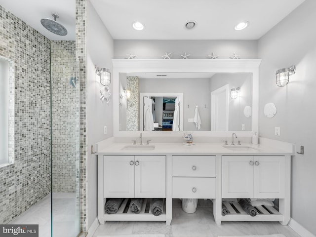 bathroom featuring a shower with shower door, tile floors, and double vanity