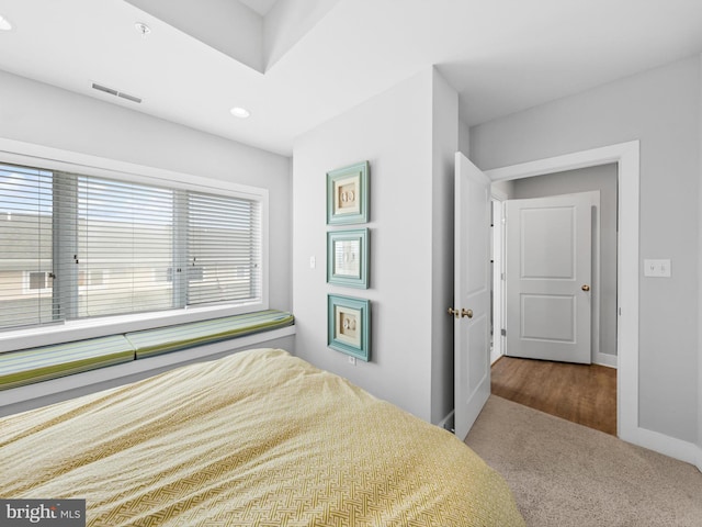 bedroom featuring dark colored carpet