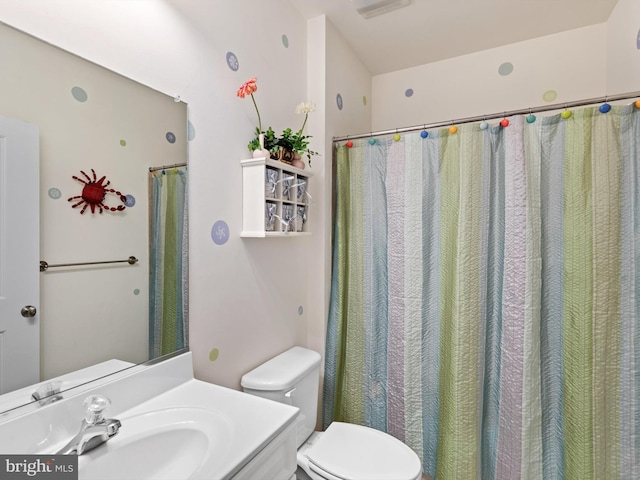 bathroom featuring toilet and vanity