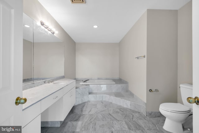 bathroom featuring tile floors, toilet, vanity, and a washtub