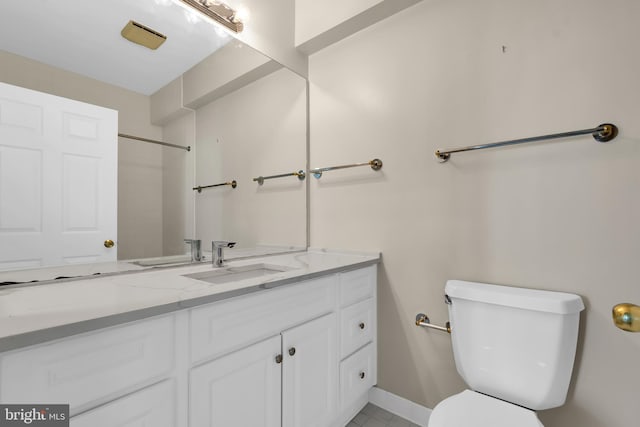 bathroom featuring toilet, tile flooring, and vanity