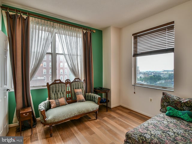 bedroom with light hardwood / wood-style floors and multiple windows