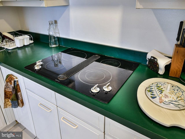 details with light tile flooring and electric stovetop