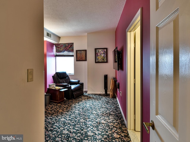 home office with a textured ceiling and light tile flooring