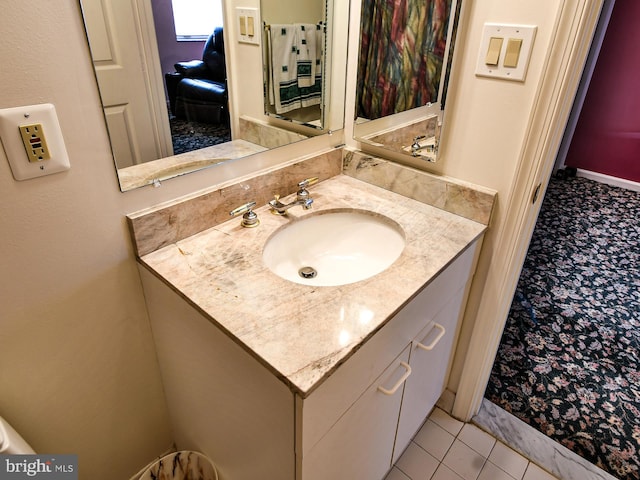 bathroom with vanity with extensive cabinet space and tile flooring