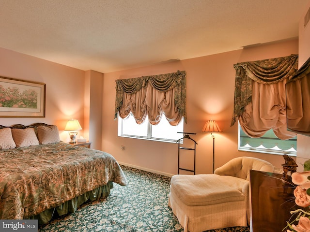 carpeted bedroom featuring a textured ceiling