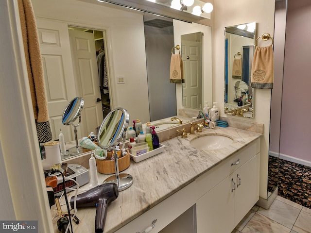 bathroom featuring vanity with extensive cabinet space and tile flooring