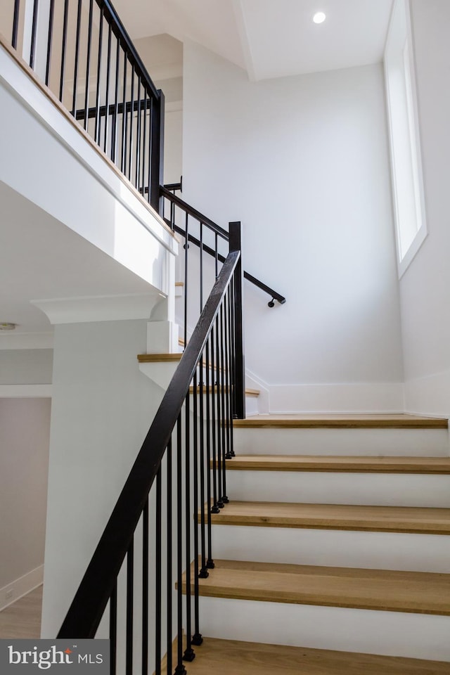 stairway with light wood-type flooring