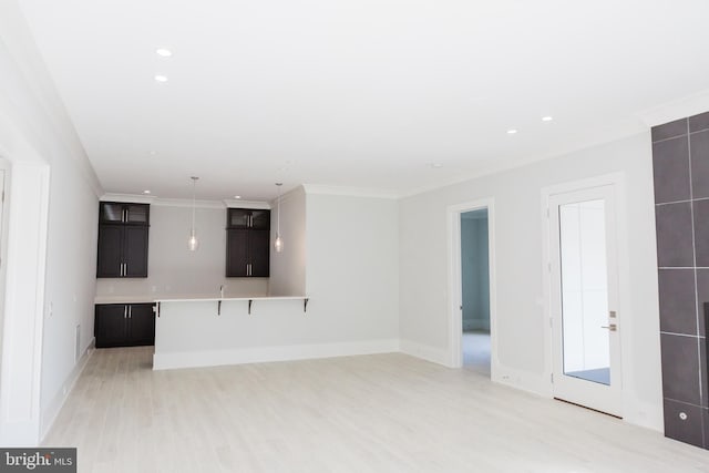 unfurnished living room featuring ornamental molding