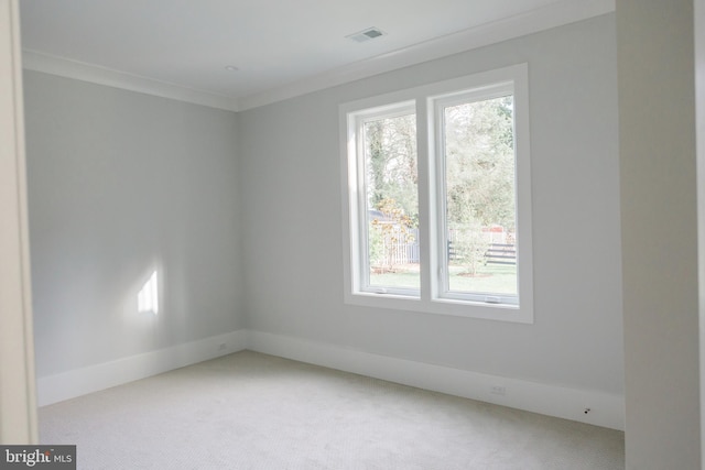 unfurnished room featuring light carpet and crown molding