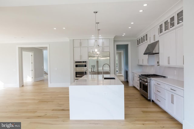 kitchen with pendant lighting, white cabinetry, and premium appliances