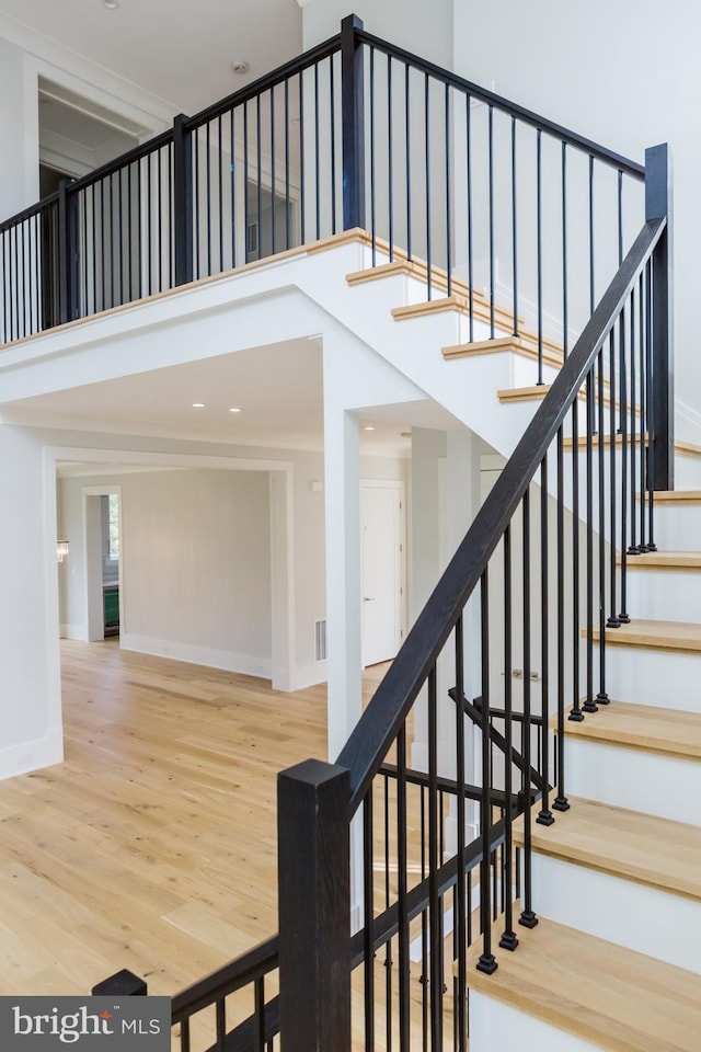 stairs with light hardwood / wood-style floors