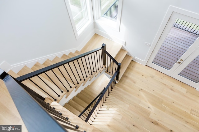 stairs with light hardwood / wood-style flooring