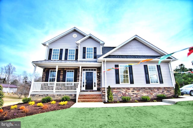 view of front of home with a porch and a front yard