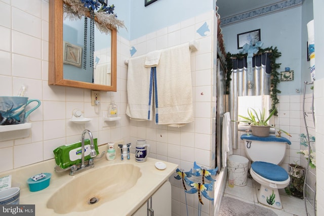 bathroom with tile walls, tasteful backsplash, toilet, and vanity