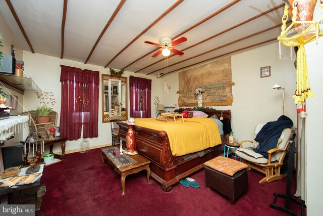 bedroom with ceiling fan, dark colored carpet, and beam ceiling