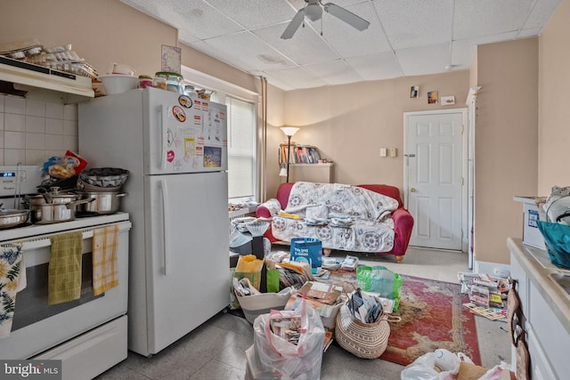 kitchen with ceiling fan, white appliances, light tile flooring, and a drop ceiling