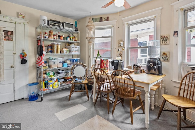 tiled dining area featuring ceiling fan