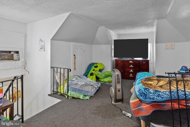 interior space with a textured ceiling and vaulted ceiling