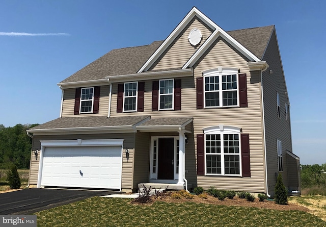 view of front facade with a front yard and a garage