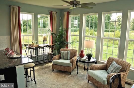 sunroom featuring ceiling fan